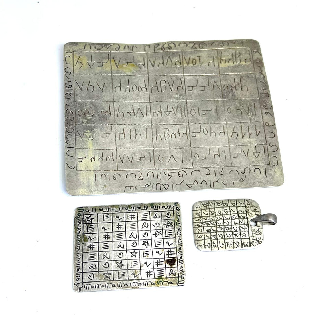 A large magic square silver pendants from North Africa