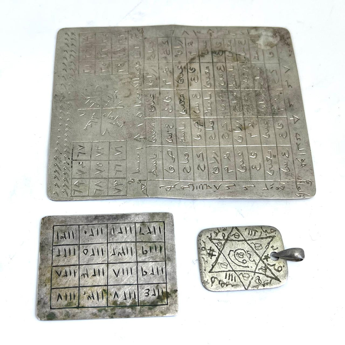 A large magic square silver pendants from North Africa